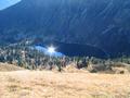 Das Spiegelbild der Sonne blendet vom Groen Scheibelsee herauf